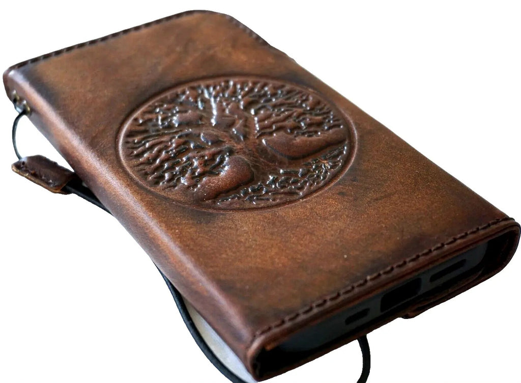 Handmade leather phone case by DAVISCASE with vintage Tree of Life design for iPhone models, featuring a magnetic wallet-style cover.