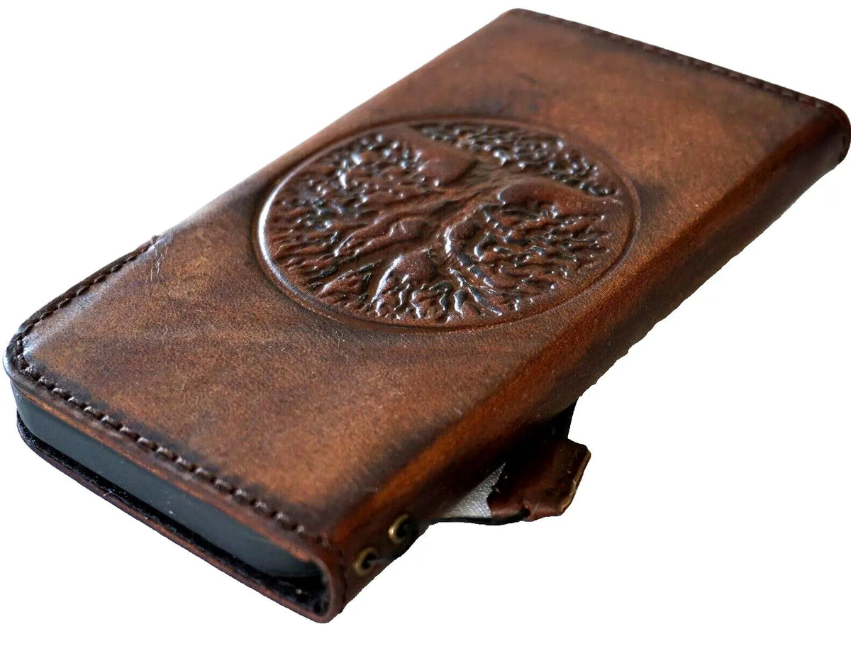 Handmade genuine leather phone case by DAVISCASE for iPhone models, featuring vintage Tree of Life design and magnetic closure.