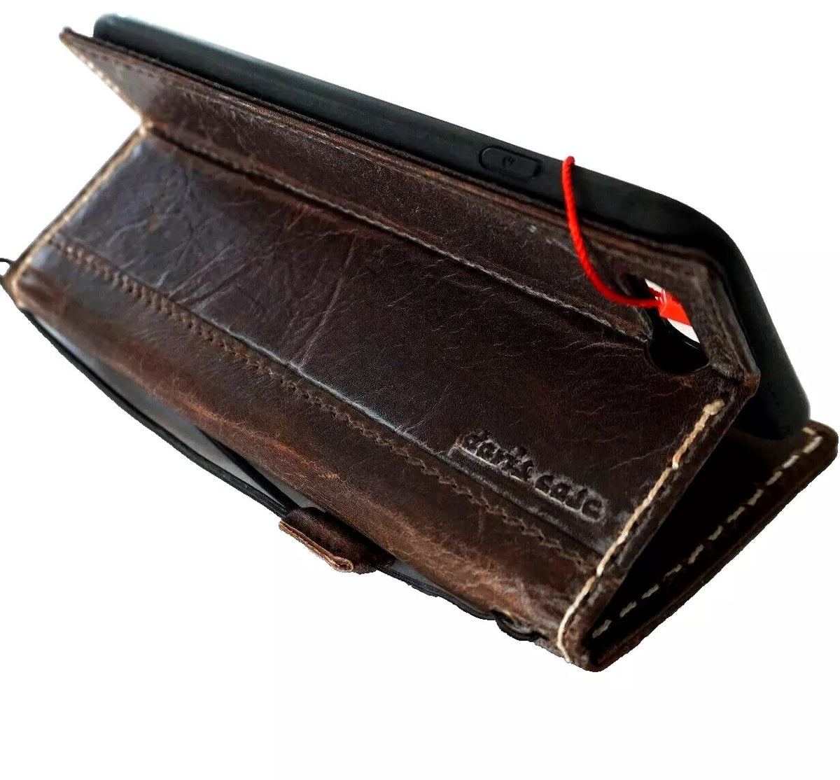 Handmade genuine leather wallet case for iPhone 12-16 Pro Max, featuring a luxurious mini book design with slight wrinkles.