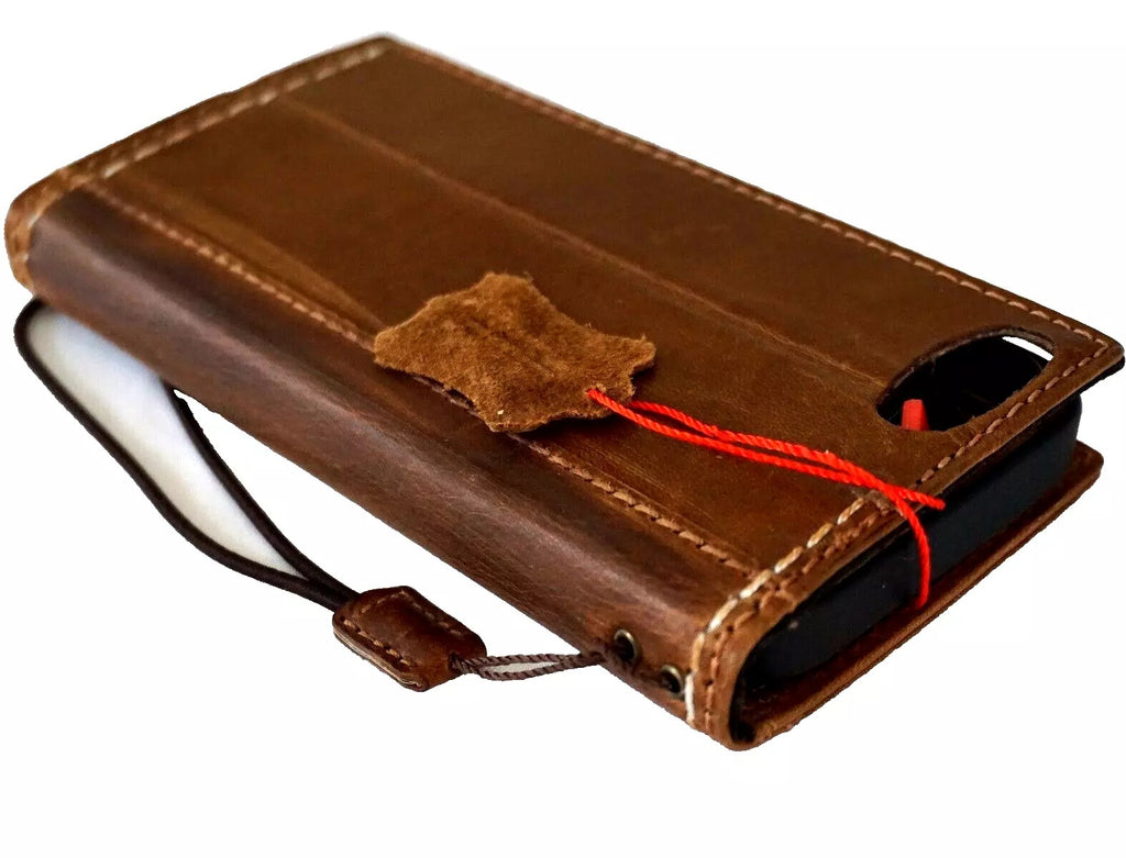 Handmade genuine leather phone case for iPhone 12 to 16 Pro Max with removable wallet by DAVISCASE, showing sewing details and craftsmanship.