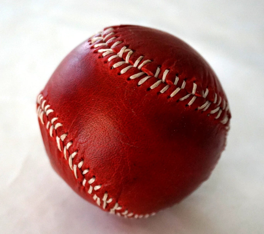 Handmade genuine leather baseball with red vintage style, sewn with thread and needle, crafted by DAVISCASE.