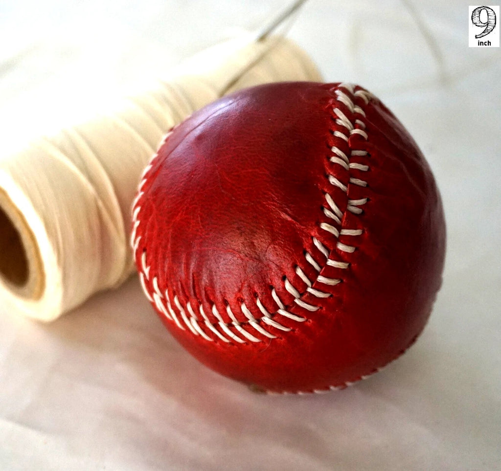 Handmade vintage red leather baseball with sewing thread and needle, crafted by DAVISCASE for a classic, artisanal look
