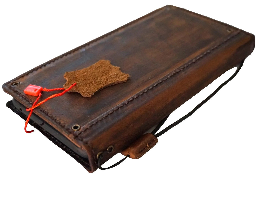 Handmade genuine leather wallet case for iPhone 8 to 17 Pro Max by DAVISCASE, featuring copper hole details and slim design.