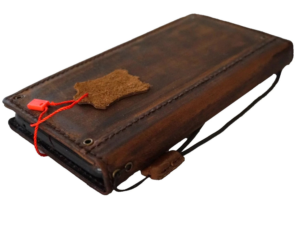 Handmade genuine leather wallet phone case for iPhone models 8 to 17 by DAVISCASE, featuring copper holes and a classic design.