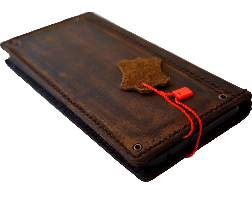 Handmade genuine leather wallet case for iPhone 8 to 17 Pro Max by DAVISCASE, featuring copper hole detail and card slots.