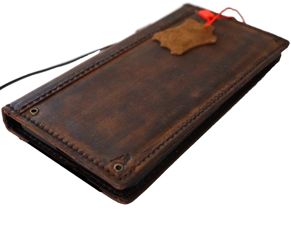 Handmade genuine leather wallet case for iPhone 17, 16, 13, 14, 15 Pro Max, 11, 12, 8 by DAVISCASE with copper hole detail.
