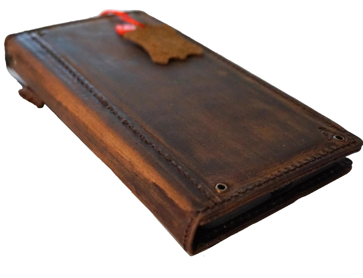 Handmade genuine leather wallet case for iPhone 8 to 17 Pro Max by DAVISCASE, featuring copper hole details and card slots.