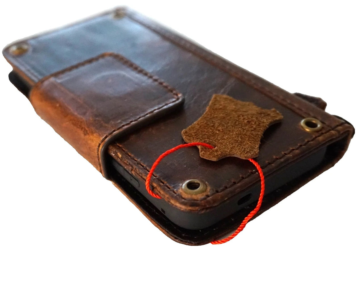Handmade genuine leather phone case for iPhone models, DAVISCASE wallet book with magnetic closure and copper accents.
