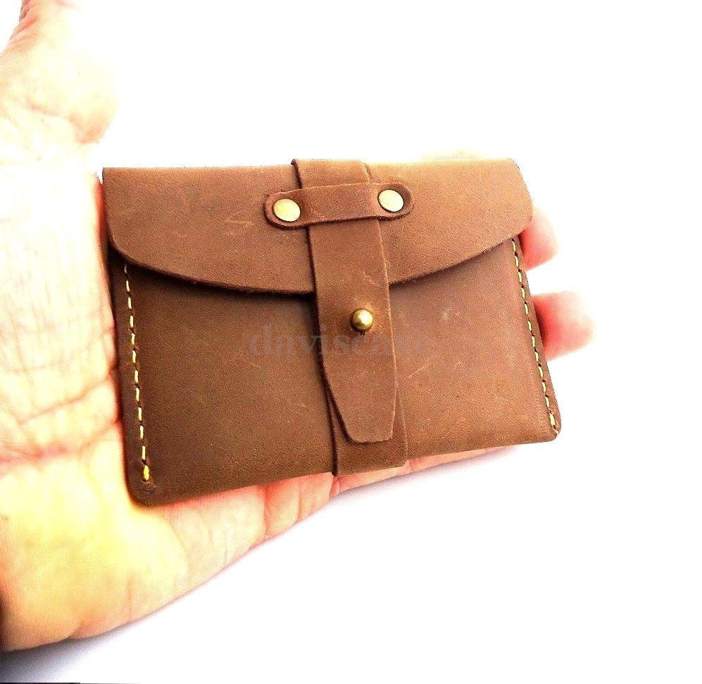 Genuine leather men's mini wallet with ID and credit card slots, compact and slim, ideal for carrying cash and cards.