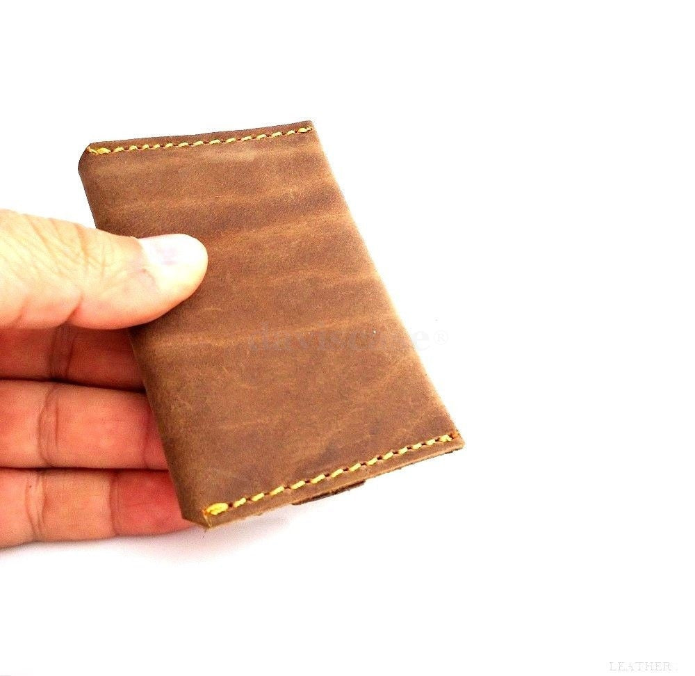 Genuine leather men's mini wallet by DAVISCASE with slim design, holding ID, credit cards, and cash in a compact pocket style.