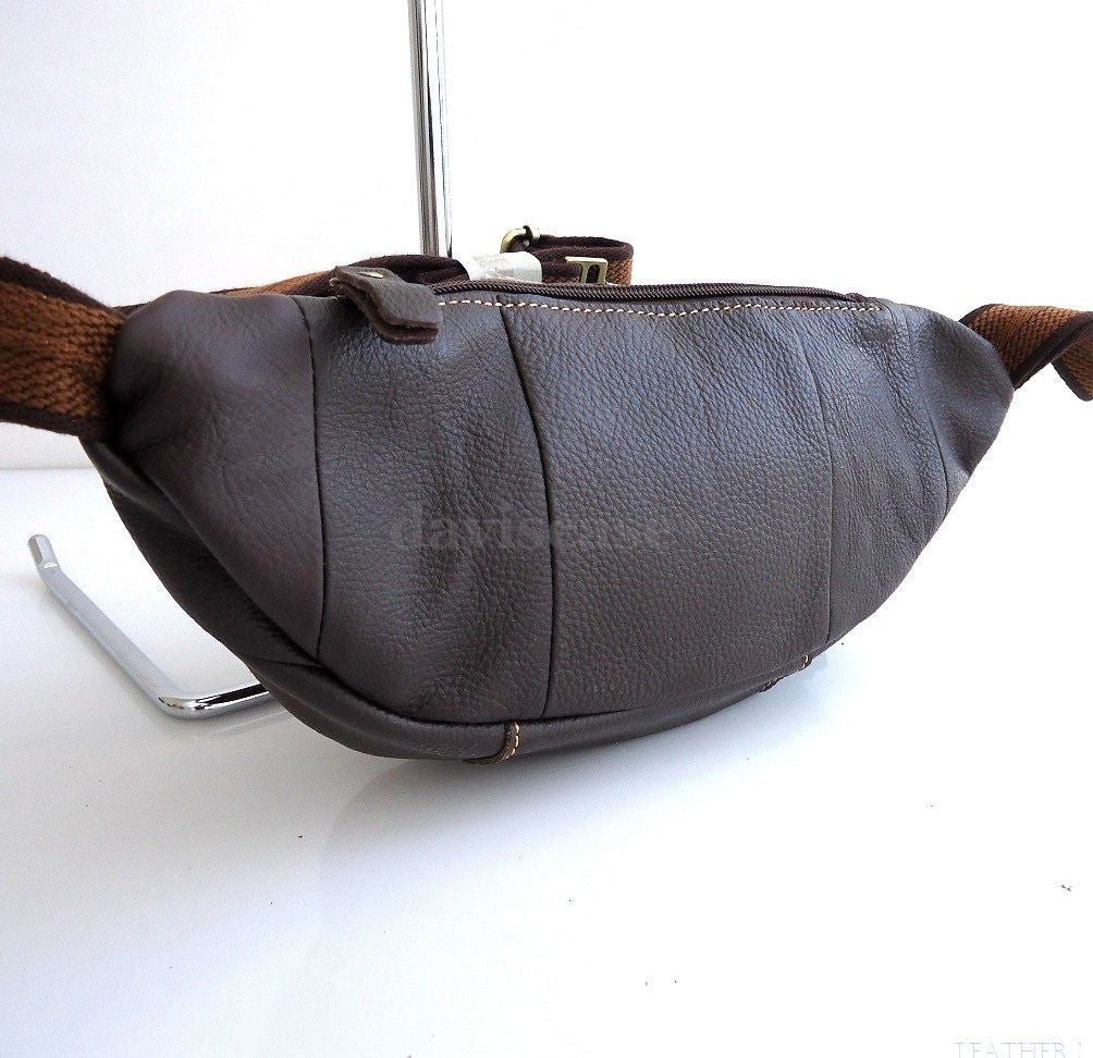 Men's genuine leather wallet bag with zipper, waist pouch, and sling design, suitable for carrying a cellphone and essentials.