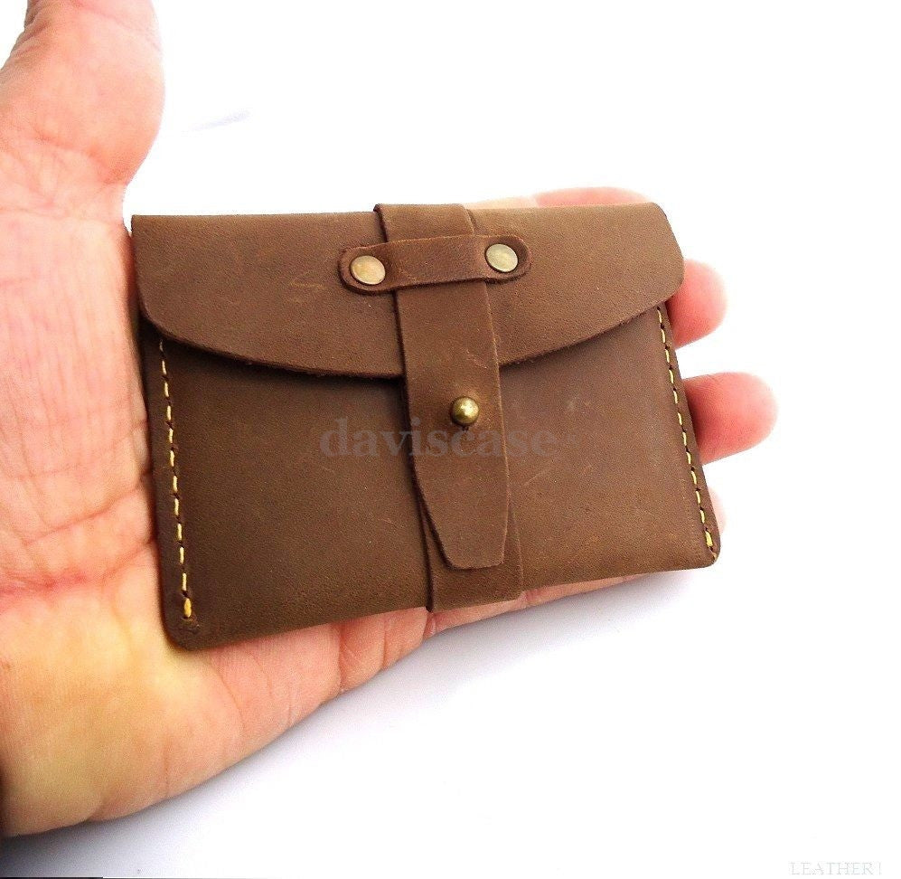Men's genuine leather mini wallet with multiple card slots and cash compartment, compact and stylish for everyday use.