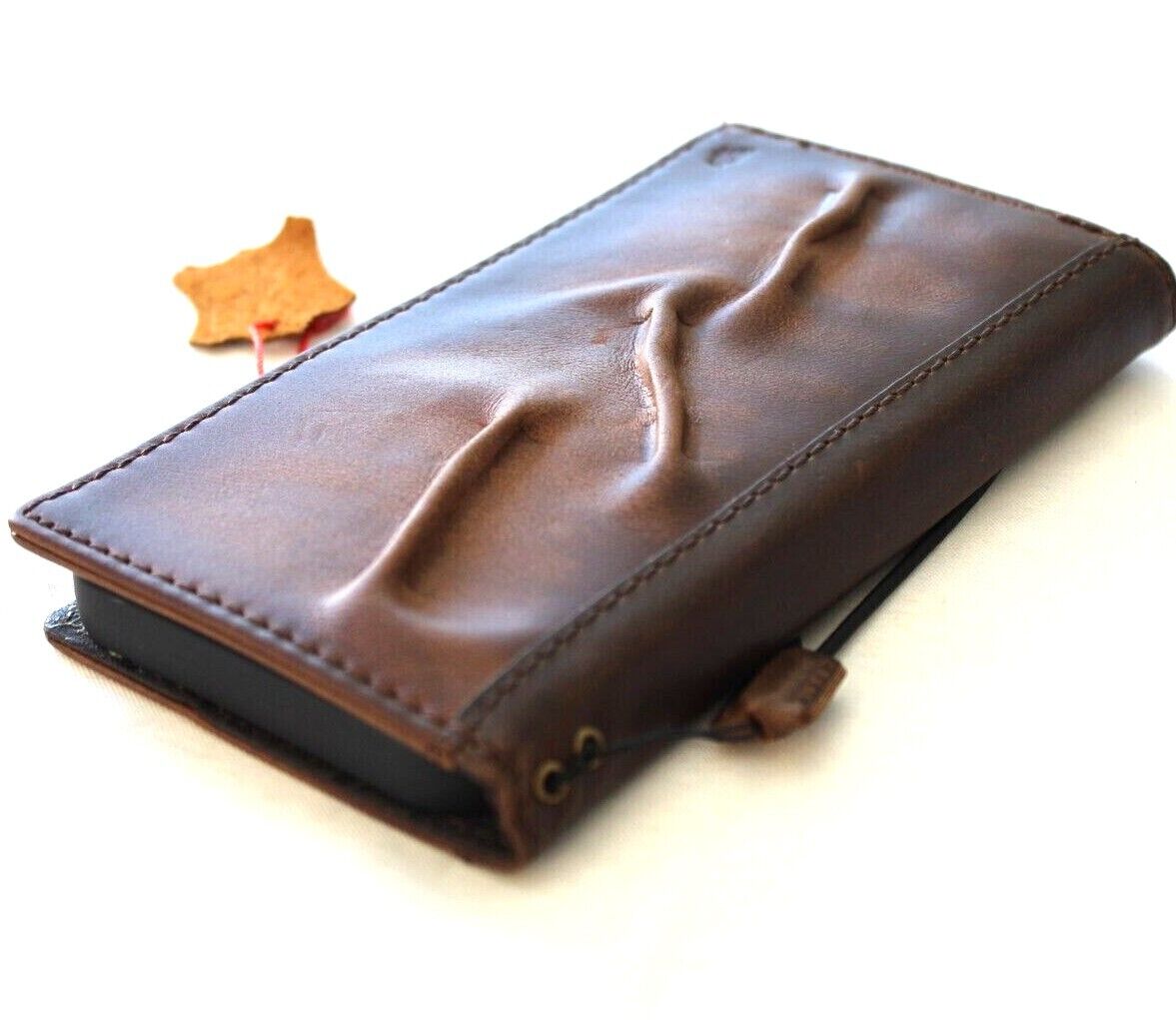Handcrafted genuine leather phone case for Apple iPhone models, vintage style with card slots, full grain leather, and artistic detailing.