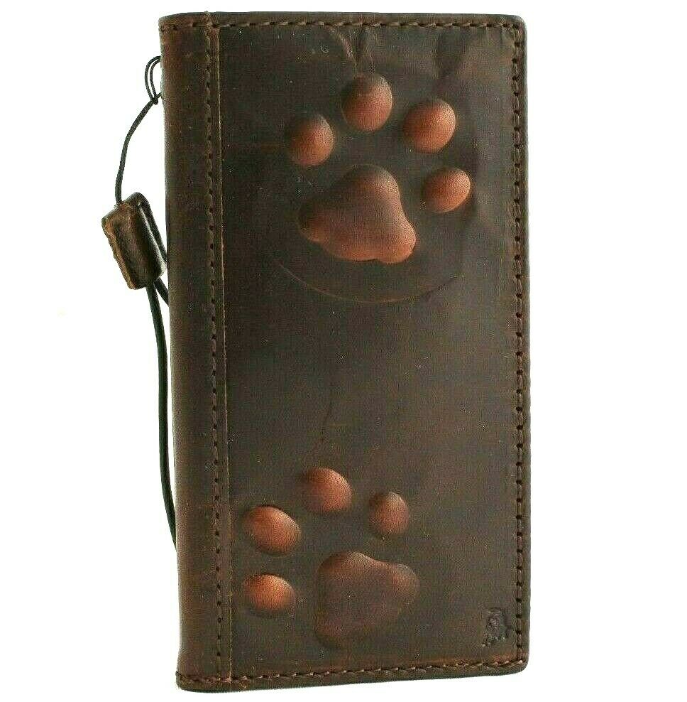 Handmade leather phone case for iPhone models with wallet and credit card slots, featuring a vintage dog paw design.