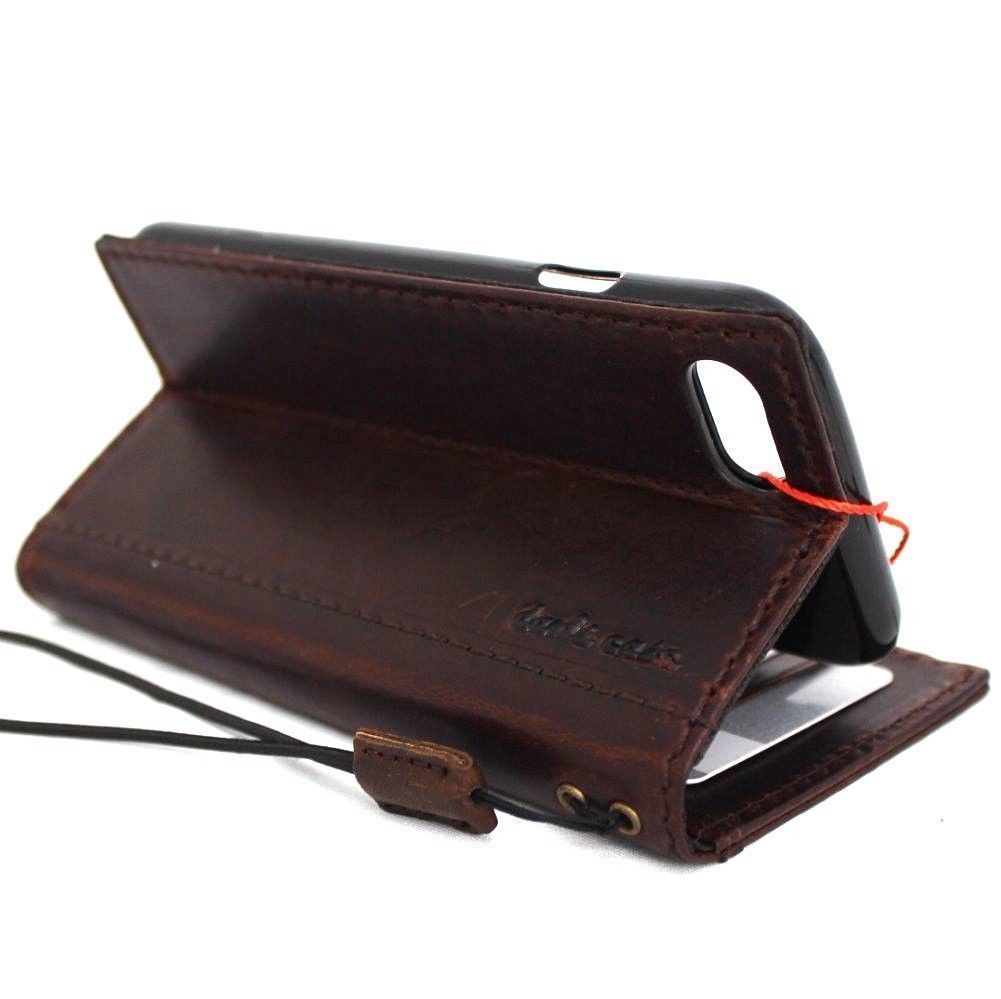 Genuine full leather iPhone 8 case with wallet design, elastic strap, and space for cards, compatible with wireless charging.