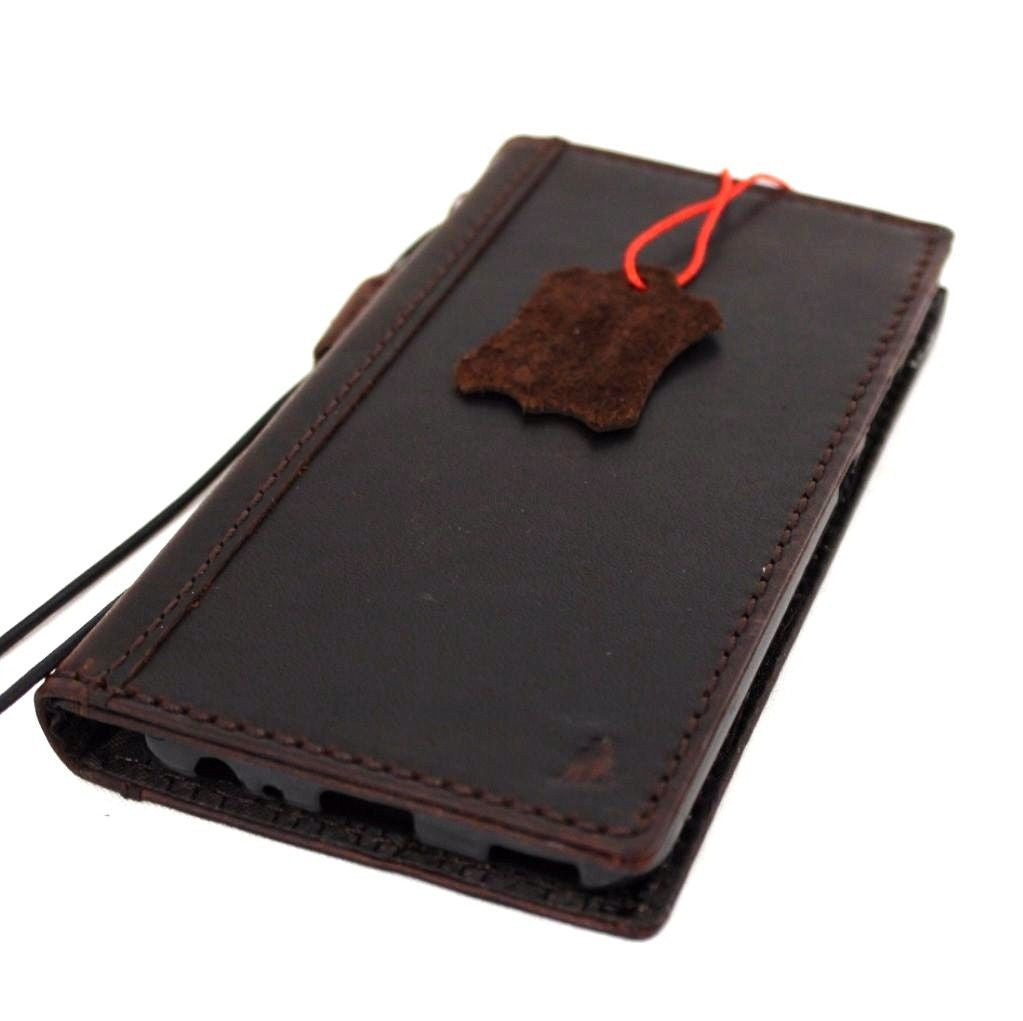 Handmade genuine leather phone case for Huawei P10, retro book wallet style, by DAVISCASE, with detailed craftsmanship and classic design.