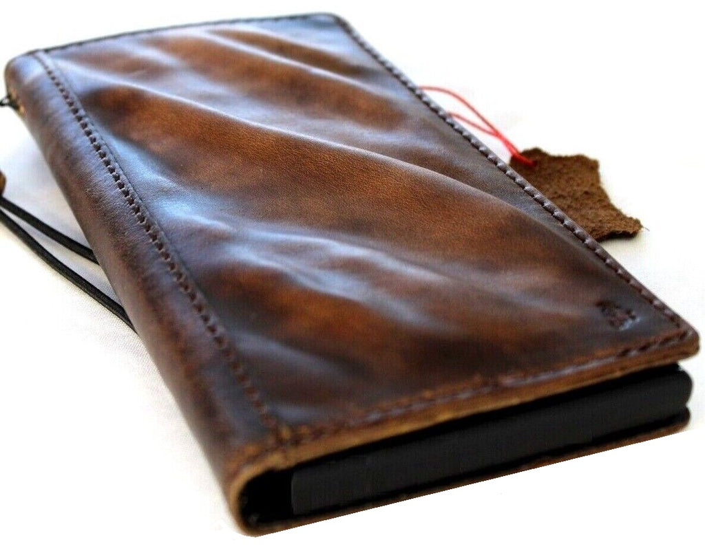 Handcrafted genuine leather phone case for iPhone and Samsung, vintage style with card slots, full grain leather, and intricate craft details.
