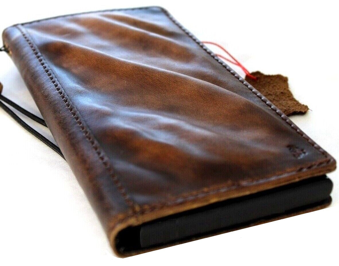 Handcrafted genuine leather phone case for iPhone and Samsung, vintage style with card slots, full grain leather, and intricate craft details.