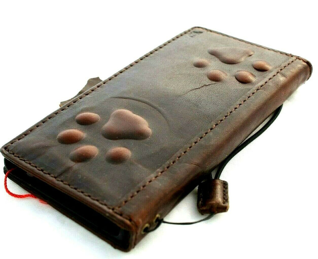 Handmade leather phone case for iPhone models with vintage dog paw design and wallet features, by DAVISCASE.