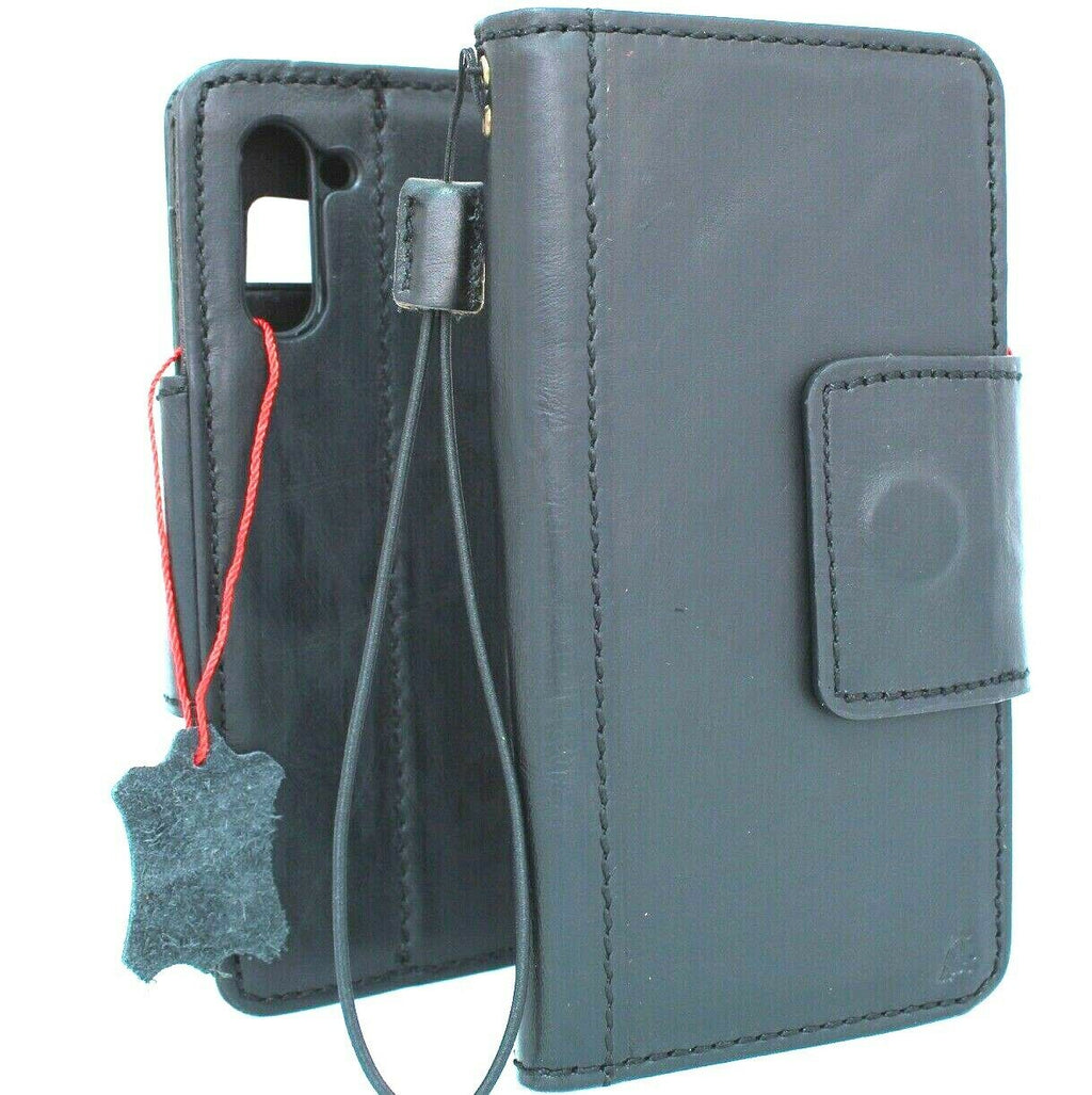Black genuine leather Samsung Galaxy Note 10 book wallet case with magnetic stand, soft interior, and wireless charging compatibility.