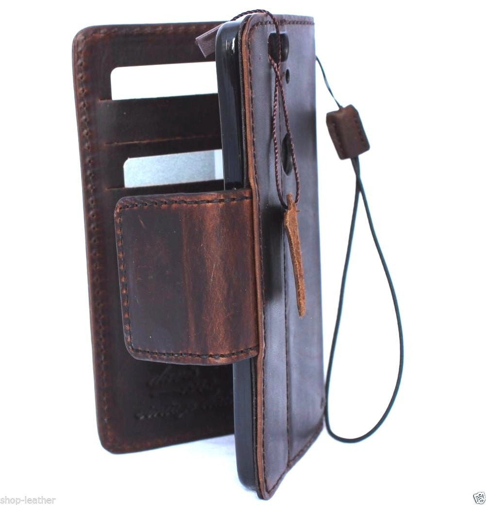 Handmade brown leather phone case with magnetic closure for Huawei Nexus 6P, featuring a vintage book wallet design.