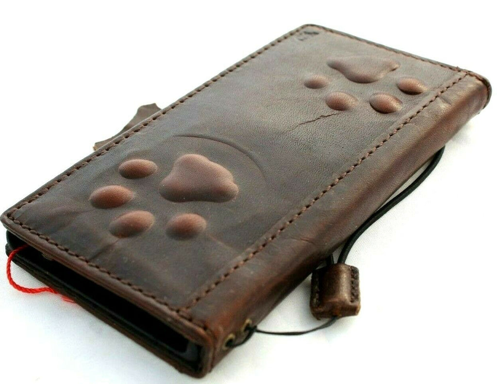Handmade genuine leather phone case by DAVISCASE for iPhone models, featuring vintage credit card slot and dark dog paw design.