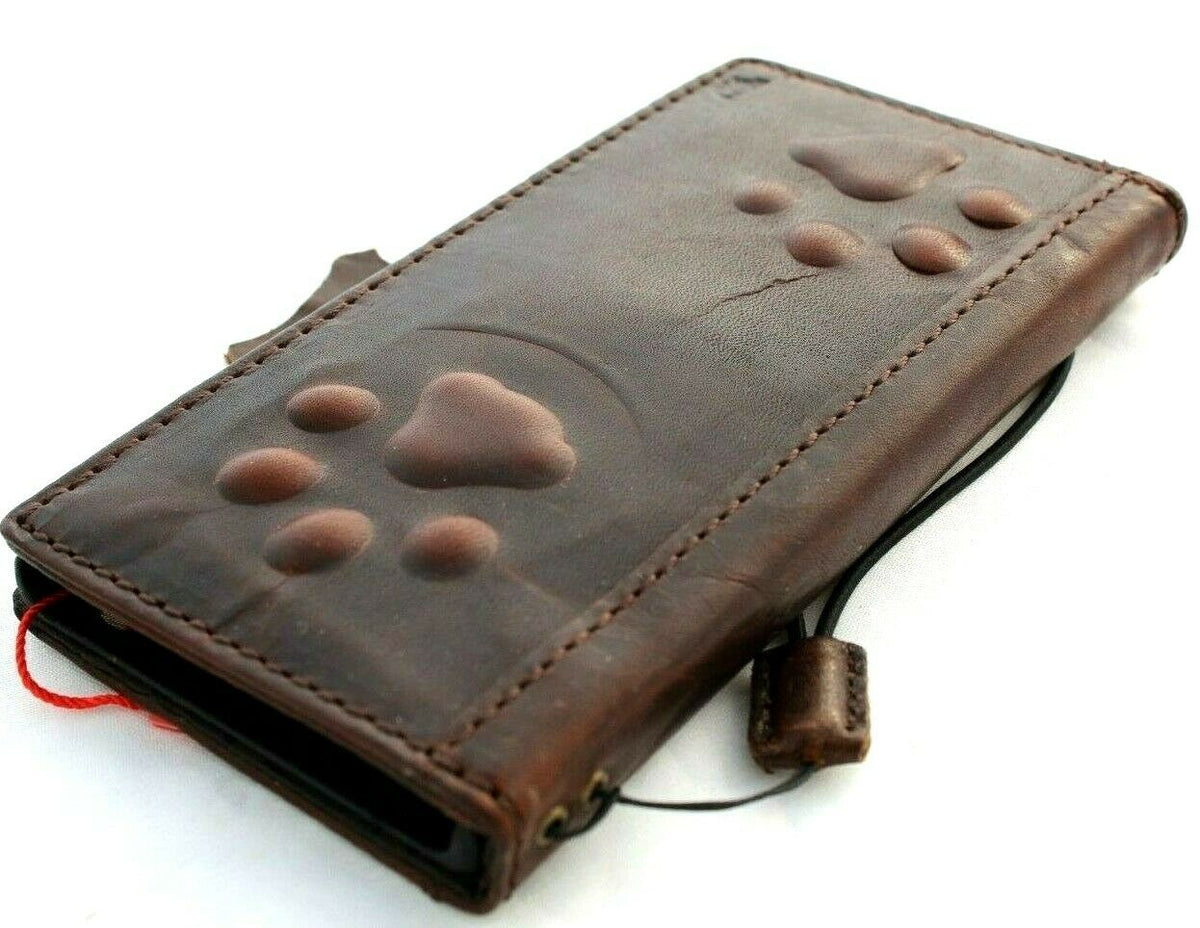 Handmade genuine leather phone case by DAVISCASE for iPhone models, featuring vintage credit card slot and dark dog paw design.
